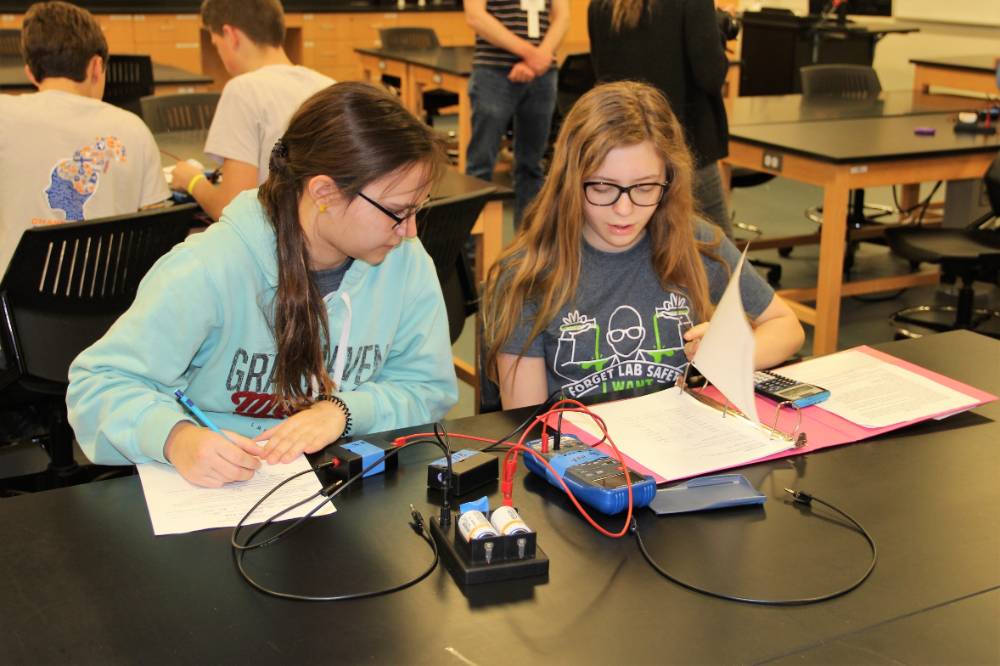 two students working on circuits